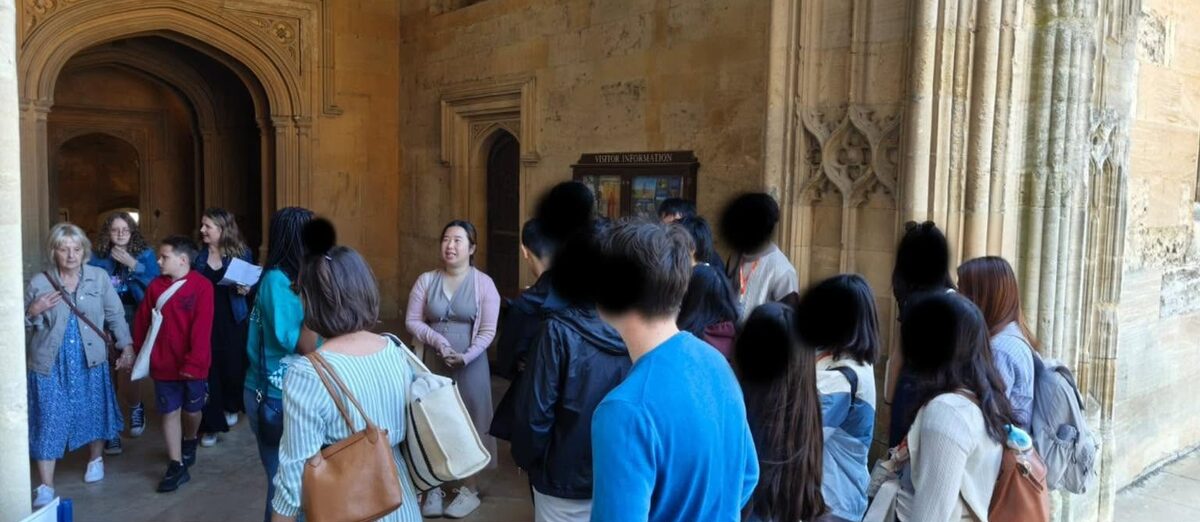 A guide briefing a group during a walking tour inside Christ Church, Oxford